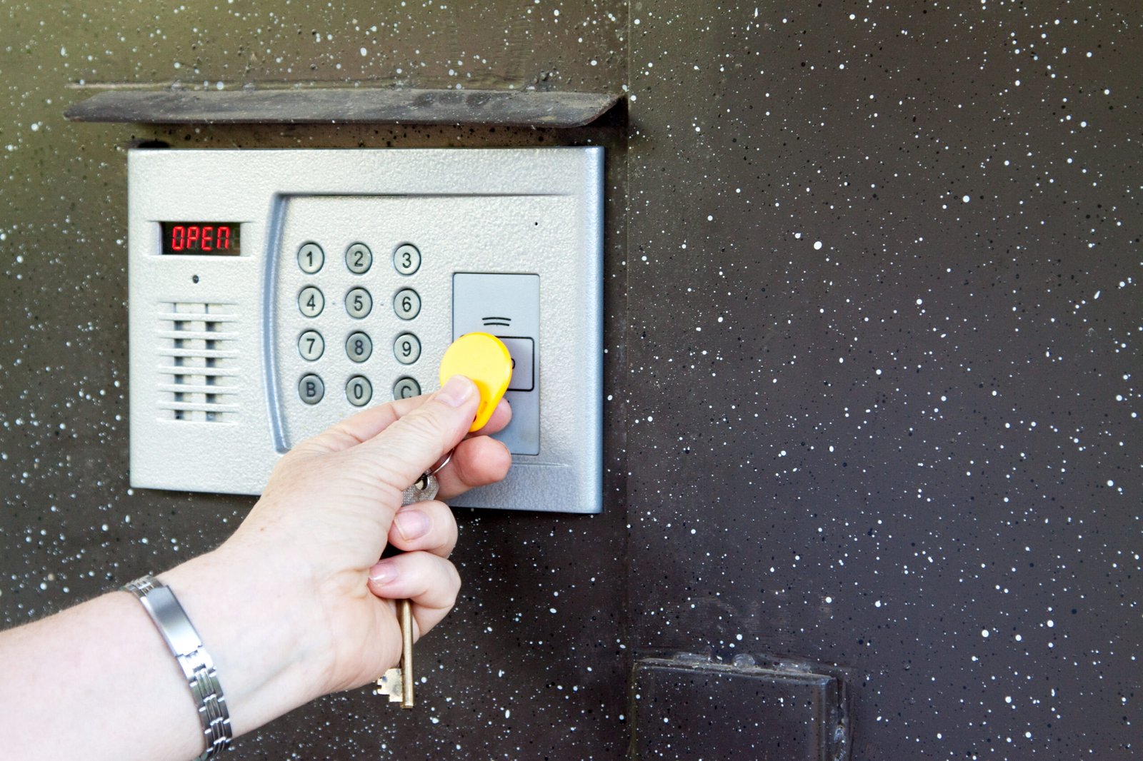 Close-up of uses intercom in steel door
