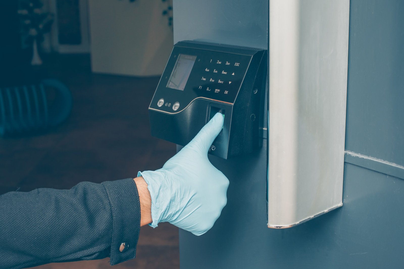 man-getting-intercom-read-his-fingerprint-open-door-with-gloves