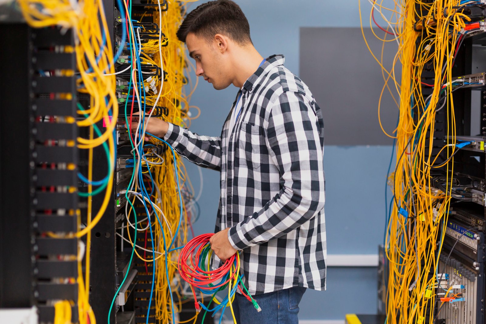 young-network-engineer-with-ethernet-wires-medium-shot